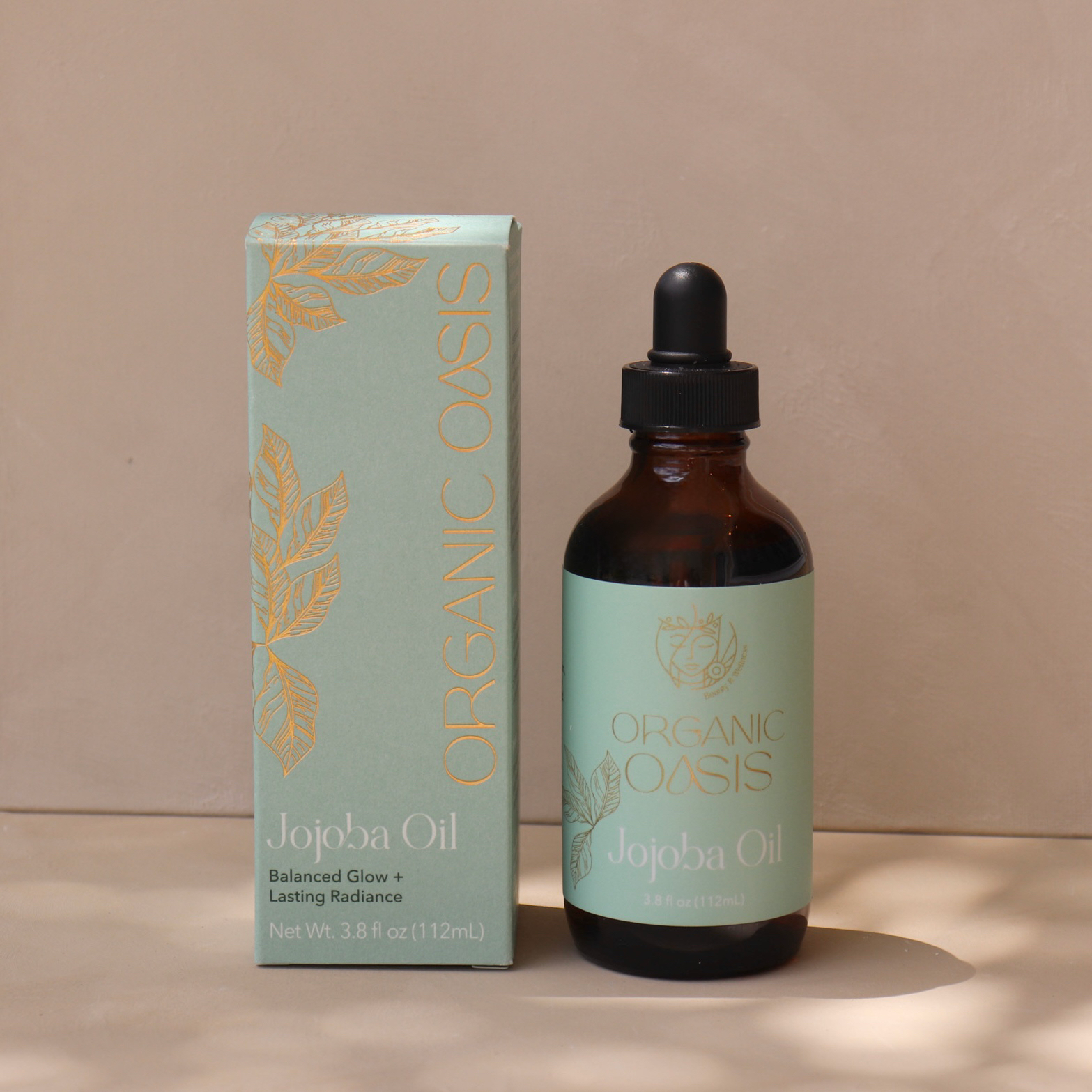 Organic Golden Jojoba Oil bottle with product box by Organic Oasis