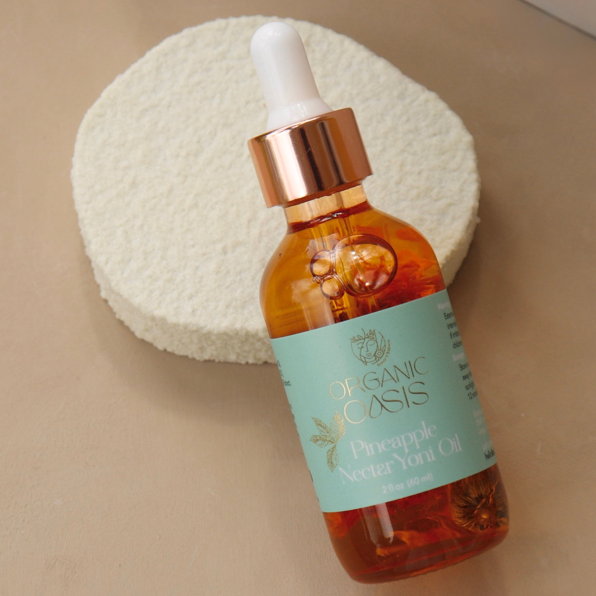 Pineapple Intimate Oil bottle with botanical skincare packaging