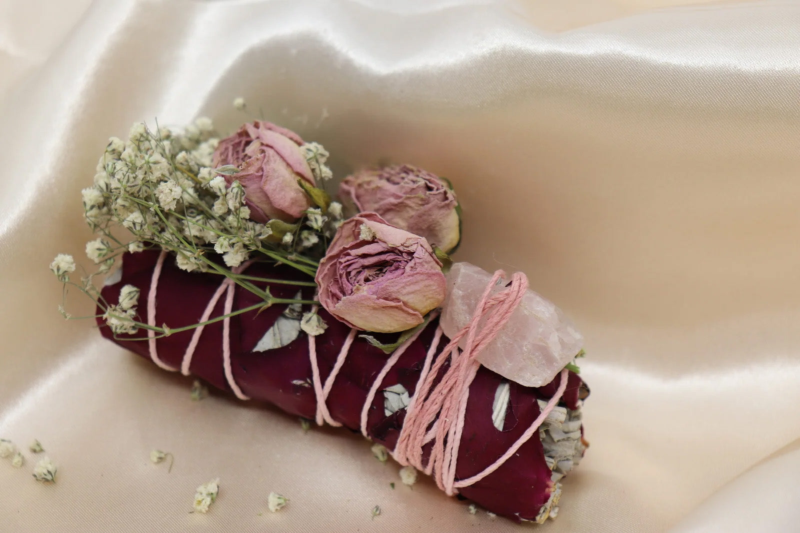 Hand-wrapped sage bundle with rose quartz crystal