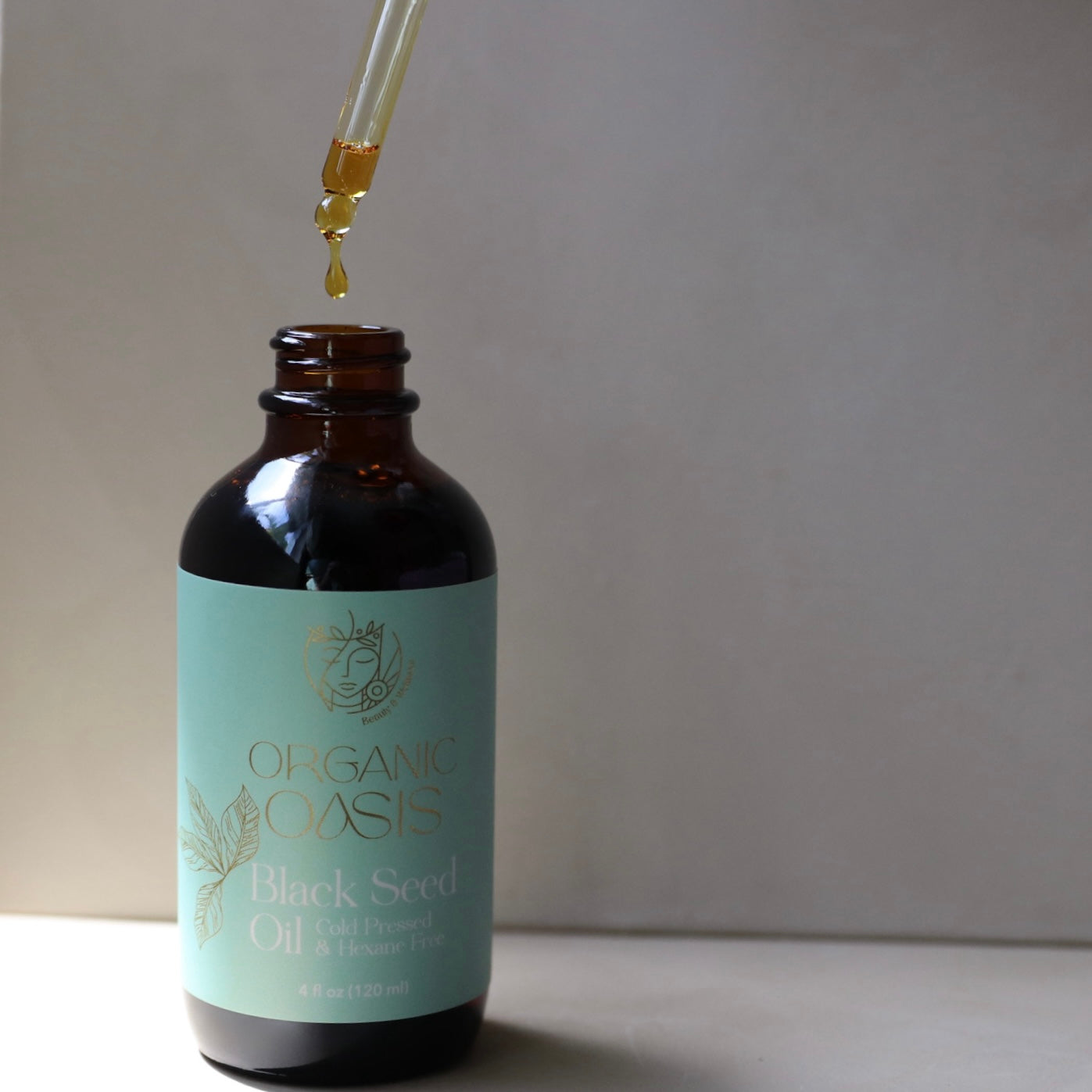 Black seed oil dropper dispensing golden oil
