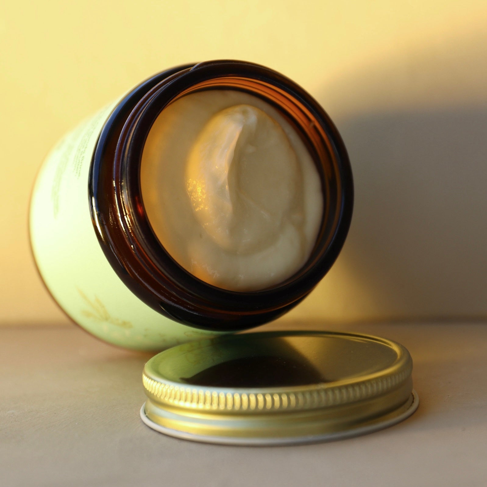 Open jar of magnesium body butter by organic oasis
