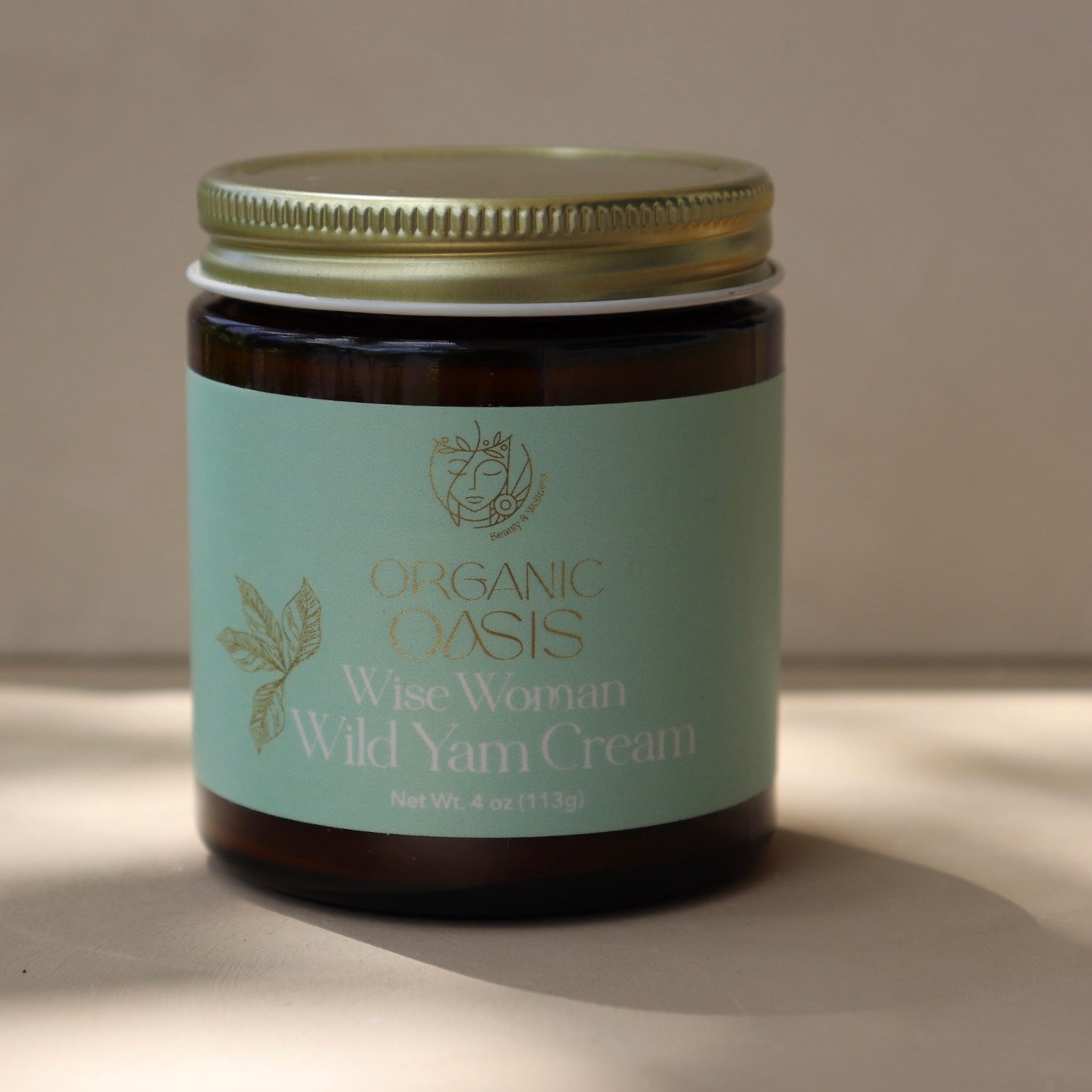 Wise Womb Wild Yam Cream by Organic Oasis in a glass jar

