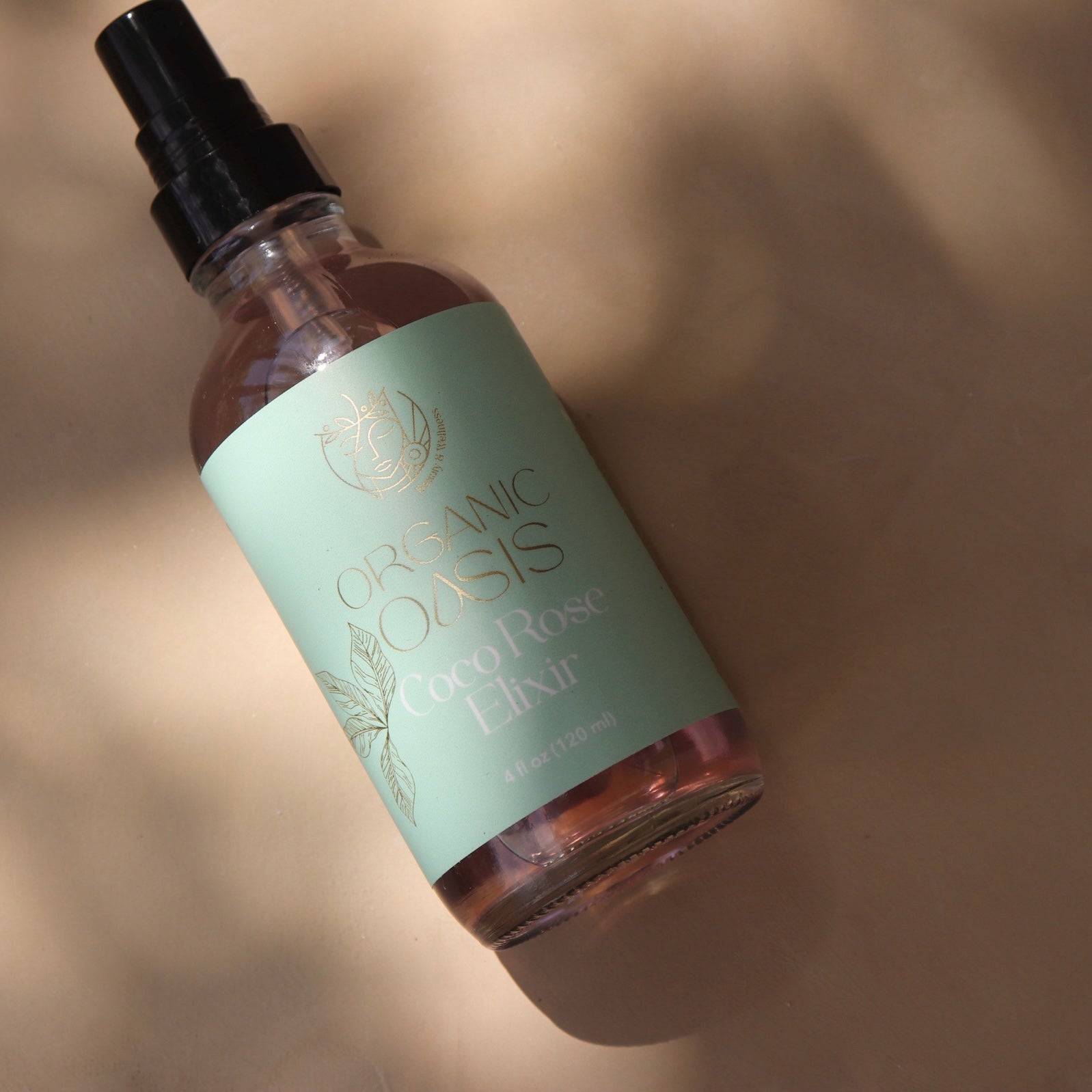 Rose water and coconut water facial mist in glass spray bottle