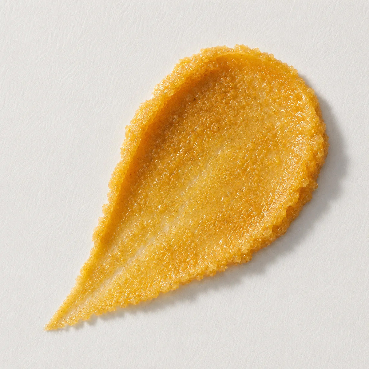 Golden turmeric body scrub texture with mineral salt and manuka honey