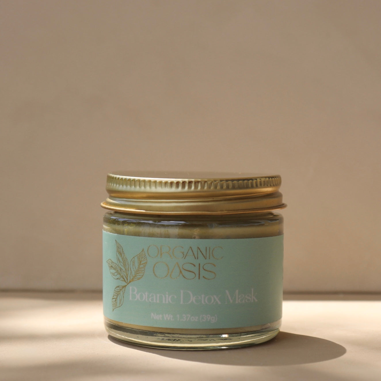 Jar of Organic Oasis Botanic Detox Mask on a neutral background