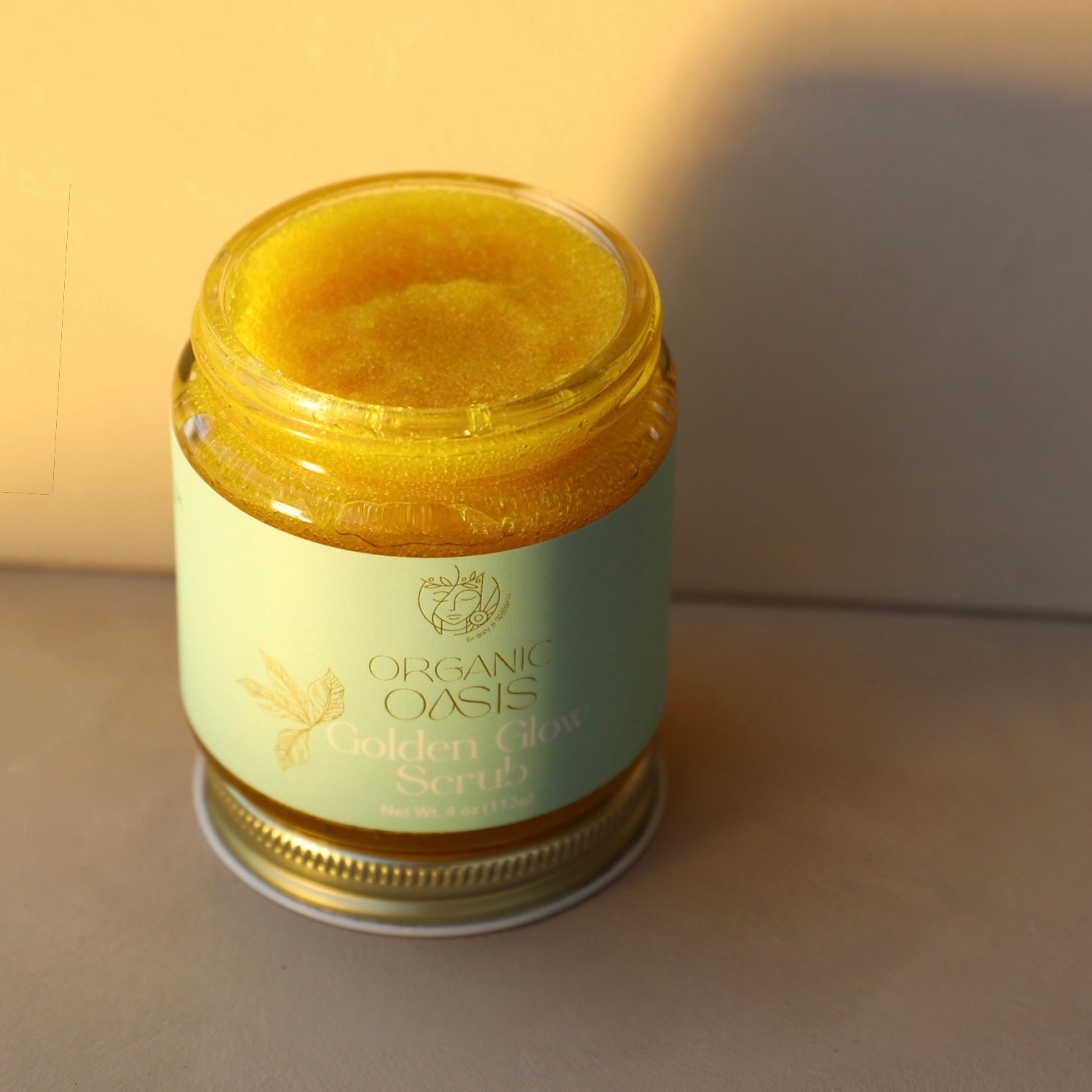 Natural turmeric and manuka honey body scrub in glass jar