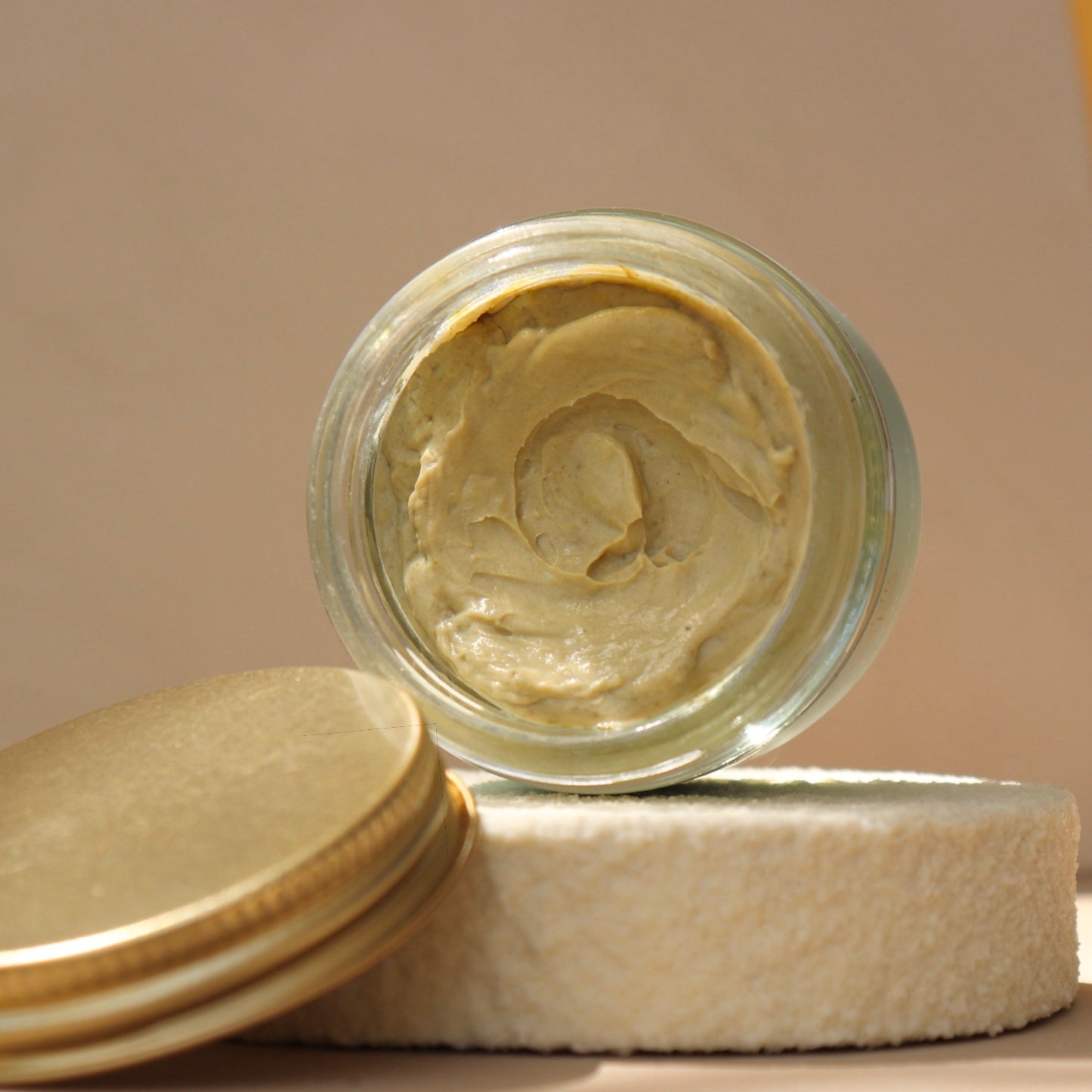 Open jar of organic matcha clay face mask
