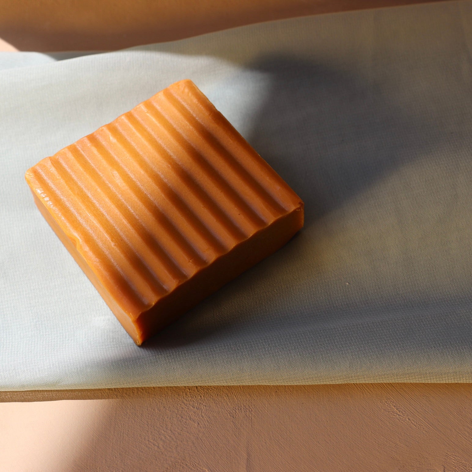 Turmeric carrot honey soap bar angled view