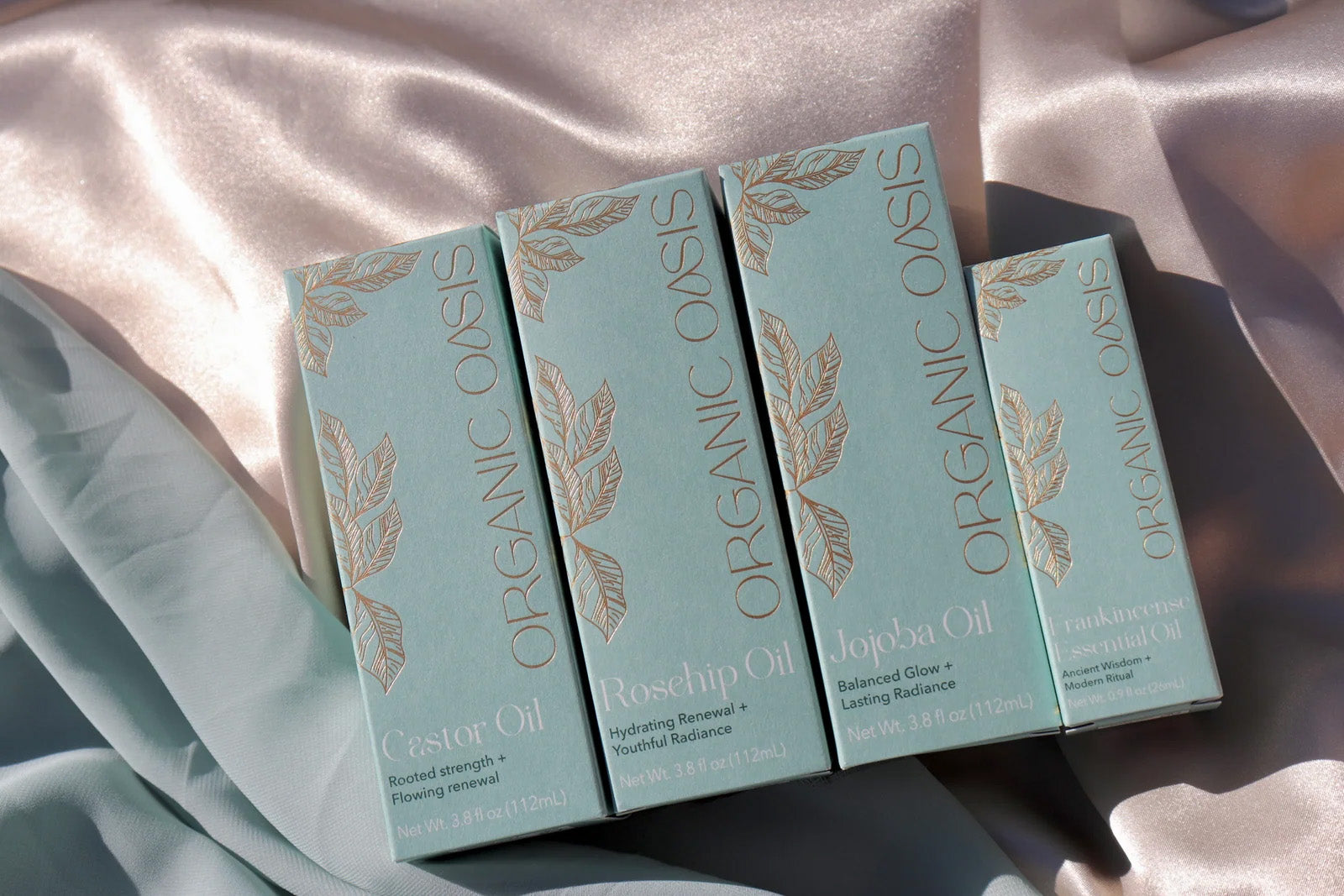 Organic Oasis Luminous Collection featuring botanical skincare oils in premium packaging.
