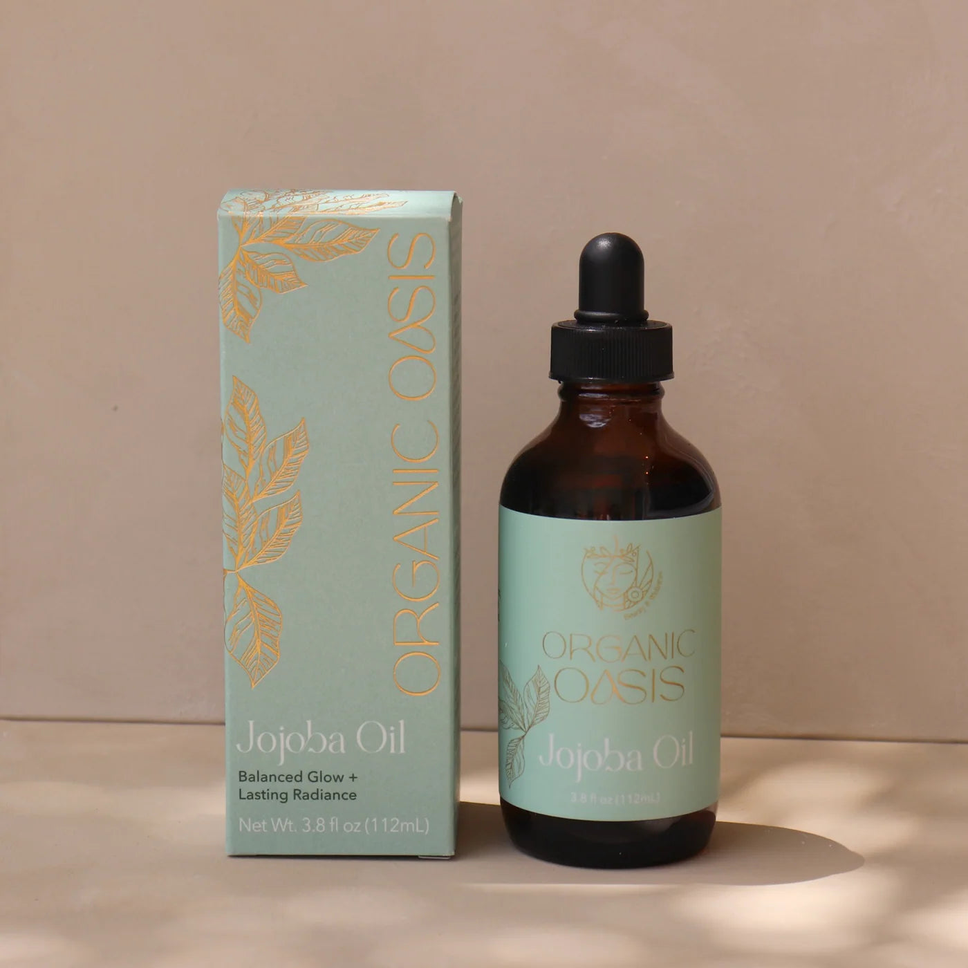 Organic Golden Jojoba Oil bottle with product box by Organic Oasis