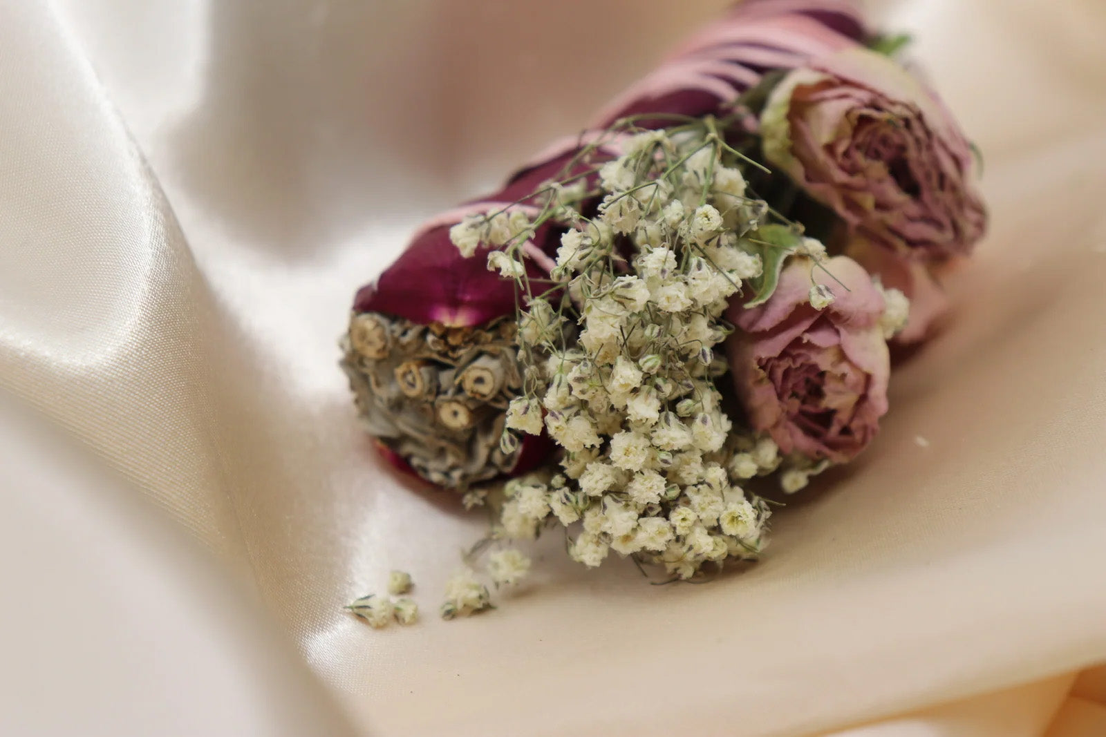 Sage and rose quartz ritual bundle with dried flowers

